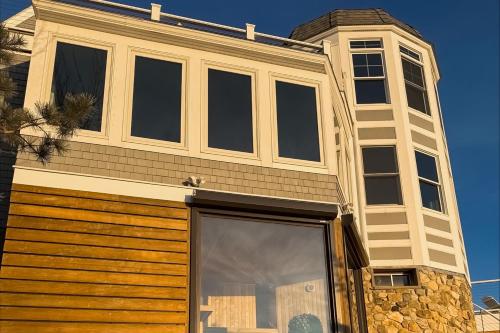 a house with a window and a building with at Barn at the Beach - Main House in Georgetown