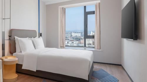 Ένα ή περισσότερα κρεβάτια σε δωμάτιο στο Holiday Inn Express Longyan Liancheng by IHG