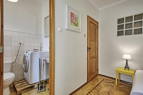 a bathroom with a toilet and a refrigerator in it at Apolónia 3 Frontal River View in Lisbon