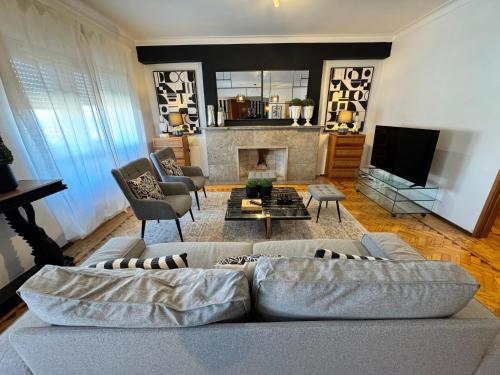 a living room with a couch and a fireplace at Apolónia 3 Frontal River View in Lisbon