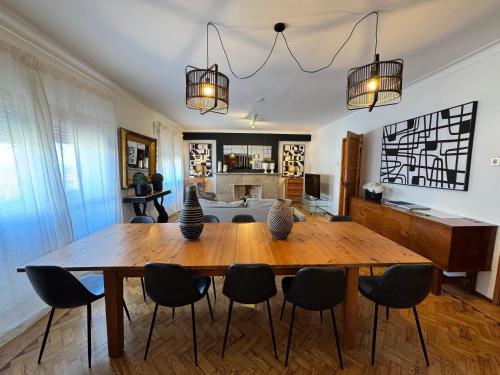 a dining room with a wooden table and chairs at Apolónia 3 Frontal River View in Lisbon