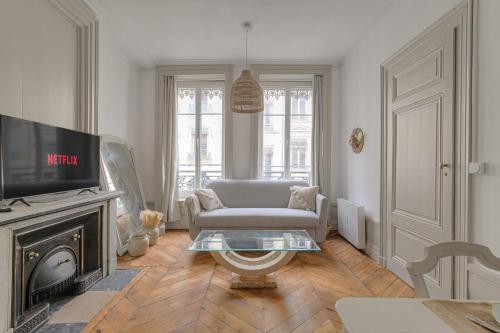 un salon avec un canapé et une télévision dans l'établissement Charmant et Chaleureux à Cordeliers, à Lyon