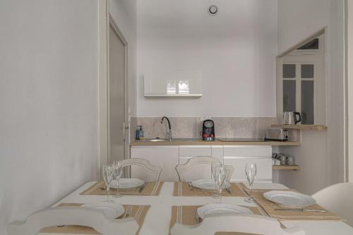 - une cuisine avec une table, 4 chaises et un évier dans l'établissement Charmant et Chaleureux à Cordeliers, à Lyon