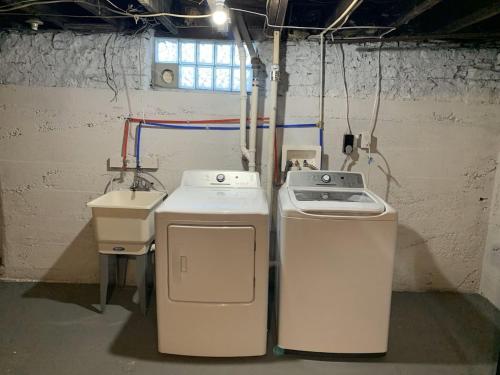 a laundry room with two machines and a sink at 4 Bedroom, 2 full bath whole house in Hamilton