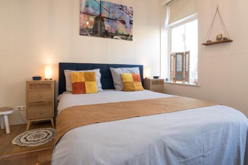 a bedroom with a large bed with two pillows at Luttik Oudorp 30 in Alkmaar