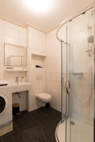 a bathroom with a toilet and a sink and a shower at Luttik Oudorp 30 in Alkmaar