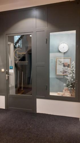 a store display window with a clock in it at 7nights Apartments Dominikánské naměstí in Brno