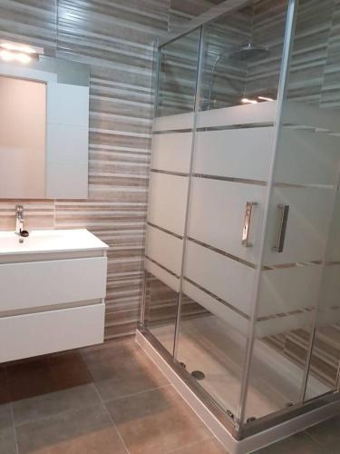 a bathroom with a glass shower and a sink at LovelyLoft Pablo Old Town in Alicante