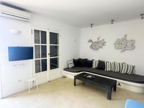 a living room with a couch and a table at White Rock Suites & Villas in Houlakia