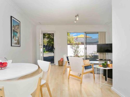a kitchen and living room with a table and chairs at Beach Getaway Villa 2BR Fun! in Bicton