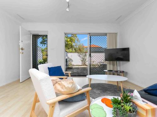 a living room with a couch and a table at Beach Getaway Villa 2BR Fun! in Bicton