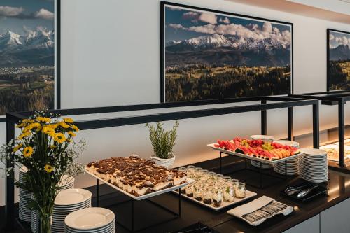 a buffet of food on a table with mountains at Rewita Kościelisko-Zakopane in Kościelisko