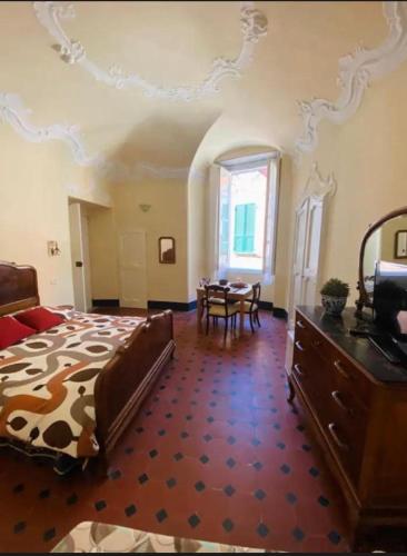 a bedroom with a bed and a table in it at La camera di Leo in Levanto