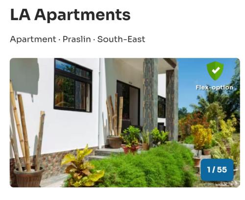 a picture of a house with plants in front of it at LA Apartments in Anse Possession