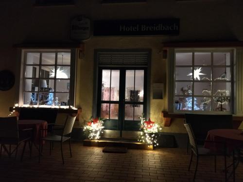 a restaurant with christmas lights in the windows at Pension Breidbach in Ensch