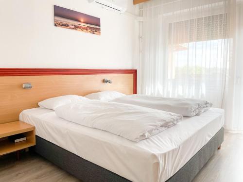 Postel nebo postele na pokoji v ubytování Tisza Sport Hotel