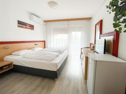 Postel nebo postele na pokoji v ubytování Tisza Sport Hotel