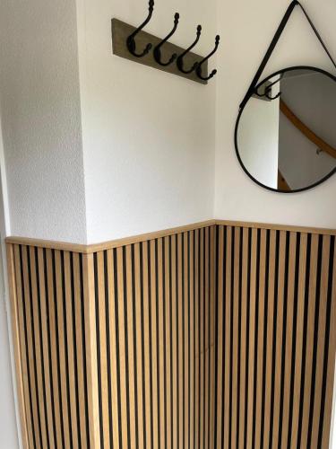 a bathroom with a mirror and a wooden radiator at Beachhouse De Dahlia in Noordwijk aan Zee