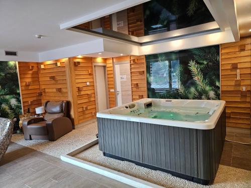a large jacuzzi tub in a living room at Hotel Han Bjelašnica in Bjelašnica