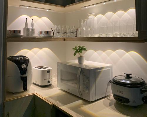 a kitchen counter with a coffee maker and a microwave at Modern Condo, Sea View, Fast Wifi, Cafe, Panglao in Dauis