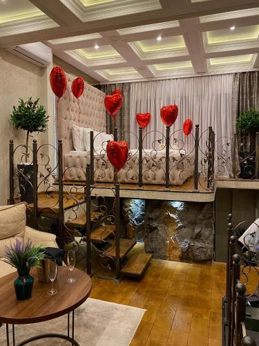 a room with a bed with red roses on it at Castello luxury spa in Novi Sad