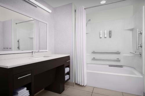 a white bathroom with a tub and a sink and a shower at Home2 Suites by Hilton Clarksville/Ft. Campbell in Clarksville