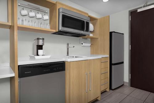 a small kitchen with a sink and a refrigerator at Home2 Suites by Hilton Clarksville/Ft. Campbell in Clarksville
