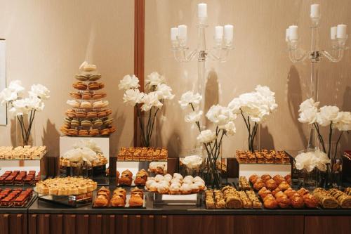 a buffet of pastries and desserts on a table at Radisson Blu Hotel, Cluj in Cluj-Napoca