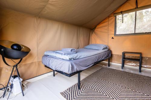 a room with a bed in a tent at Gulbity Camp in Gulbity