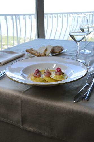 a table with a plate of food on a table at Splendid Hotel Taormina in Taormina
