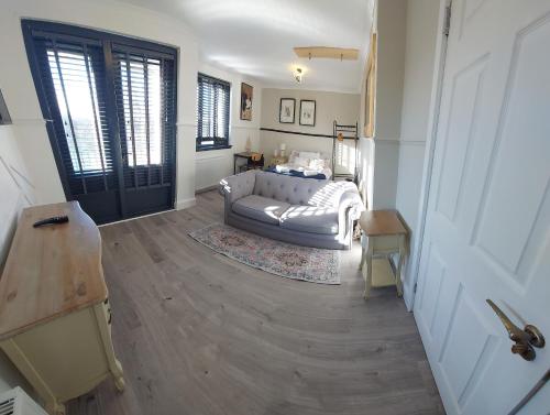 a living room with a couch and a table at Scottish Nest in the heart of East Kilbride 10mins from Hairmyres Hospital in East Kilbride