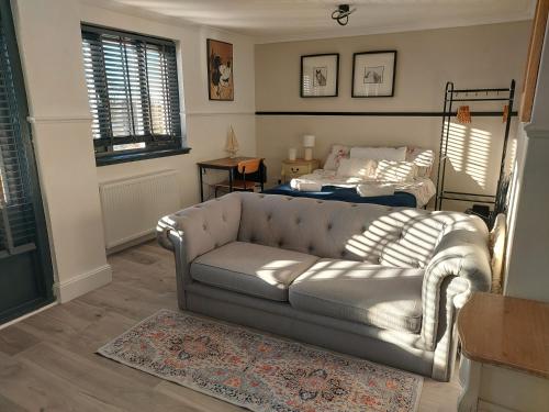 a living room with a couch and a bed at Scottish Nest in the heart of East Kilbride 10mins from Hairmyres Hospital in East Kilbride