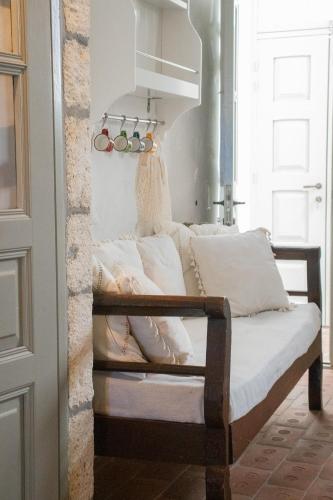 a bedroom with a bed with white pillows at Patmos Traditional House Chora near the Monastery in Patmos