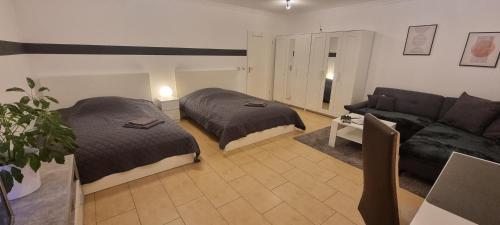 a living room with two beds and a couch at Monteurswohnung Deluxe in Spreenhagen