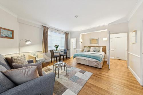 a bedroom with a bed and a living room at Nell Gwynn Chelsea Accommodation in London