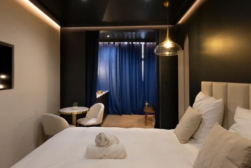 a hotel room with a bed and a table and a window at Luxury Suite Romantic Getaway with Jacuzzi in Castres