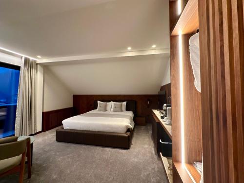 a hotel room with a bed and a desk at Hôtel Restaurant & Spa Les Planets in Les Rasses