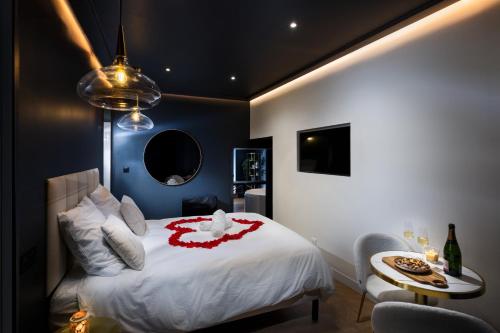 a bedroom with a bed with a red flower on it at Luxury Suite Romantic Getaway with Jacuzzi in Castres
