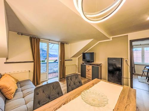 a living room with a couch and a table at Apartment Frank-2 by Interhome in Feldkirchen in Kärnten