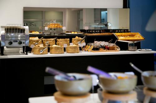 a kitchen with bowls of food on a counter at Amorgos Boutique Hotel in Larnaka