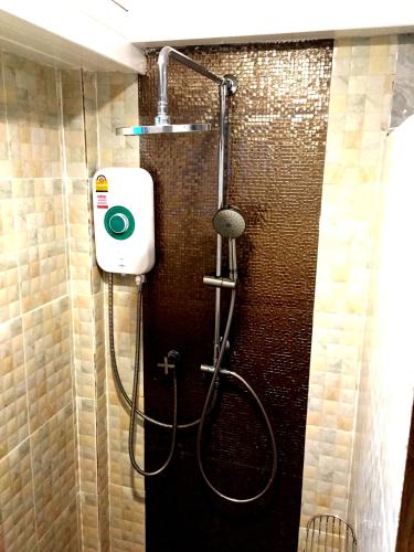 a bathroom with a shower with a shower at Aen Guy Boutique Hotel in Sukhothai