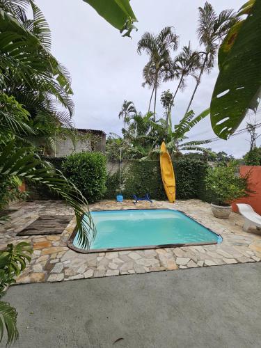 a small swimming pool in a yard with palm trees at Hospedaria do Engenho in Niterói