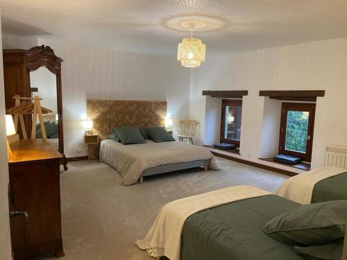 a bedroom with two beds and a mirror at Ferme Rénovée Vercors: Confort, Cheminée, Parking, Jardin Proche Pistes - FR-1-548-46 in Villard-de-Lans