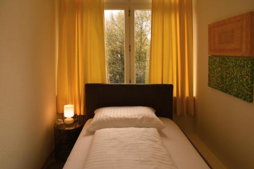 a bedroom with a bed in front of a window at Engel Apartments in Hard
