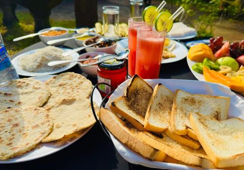 a table topped with plates of bread and sandwiches at Village Life Mihinthale in Anuradhapura