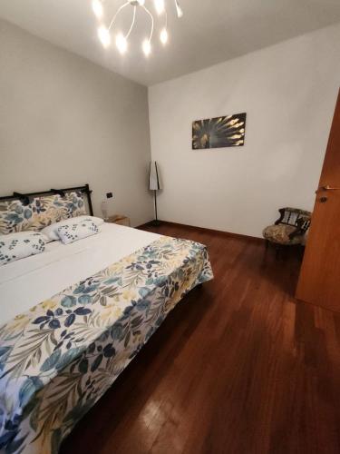 a bedroom with a bed and a chandelier at La Corte Guesthouse in Cornate dʼAdda