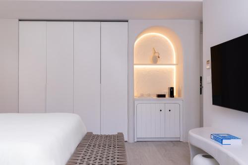 A bed or beds in a room at Patmos Aktis, a Luxury Collection Resort & Spa, Greece