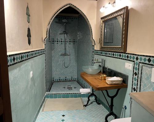 a bathroom with a sink and a shower at Riad Hanael Garden & Spa in Fès