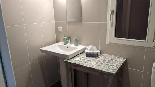 une petite salle de bain avec un lavabo et un miroir dans l'établissement Grande maison entre Lac et forêt, à Gastes