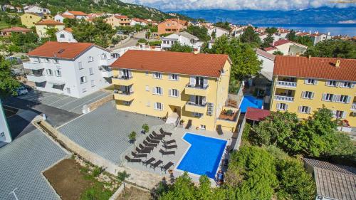 an aerial view of a building with a swimming pool at Apartments Gorica 2 in Baška